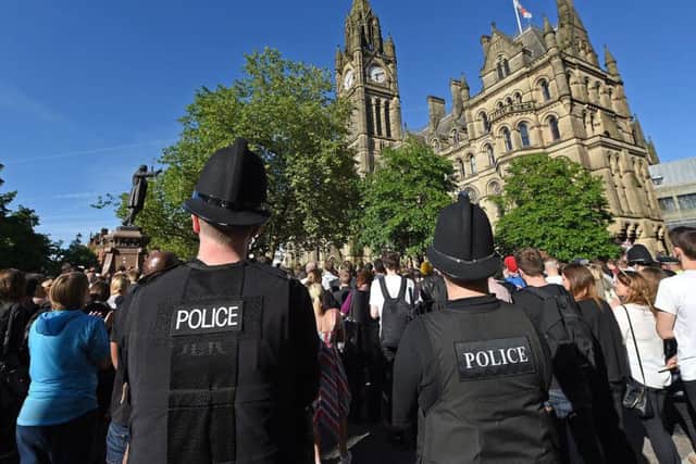 People gather for a vigil in Albert Square outside Manchester Town Hall