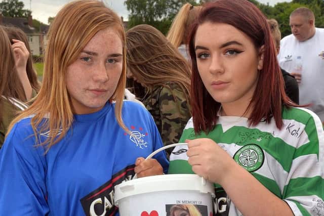 Leah Forde (left) and Brooke Hutchinson, dressed in Celtic and Rangers shirts, at a coffee evening for Caitlin in Portadown on Tuesday night