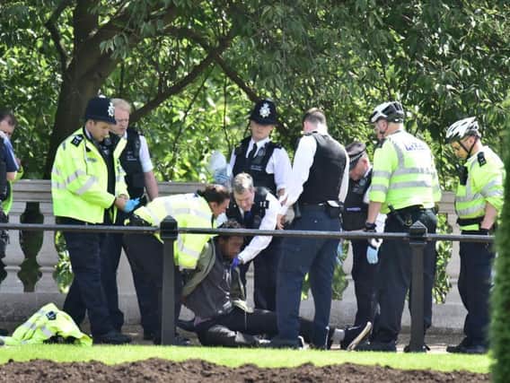 Police arrest a man who was carrying a knife near Buckingham Palace, London, in an incident which Scotland Yard said was not believed to be terror related.