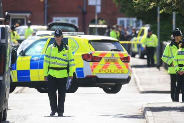 Police in Wilbraham Road, Chorlton, Manchester, following an arrest during the inquiry into the Manchester Arena suicide bombing