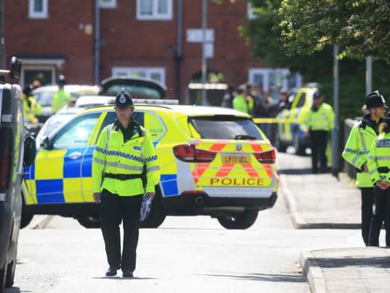 Police in Wilbraham Road, Chorlton, Manchester, following an arrest during the inquiry into the Manchester Arena suicide bombing