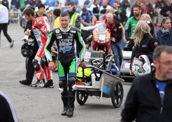 TT newcomer Adam McLean wheels away his kit after the first practice session was cancelled because of poor visibility on Saturday.