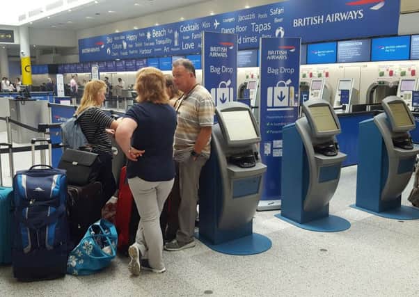 Passengers at the British Airways check-in desk at Gatwick Airport on Saturday
