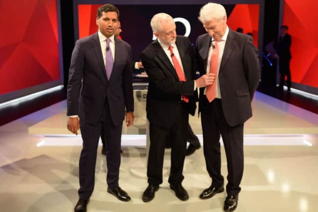 Labour leader Jeremy Corbyn (centre) adjusts the tie of Jeremy Paxman as they stand alongside Sky News political editor Faisal Islam during a joint Channel 4 and Sky News general election programme