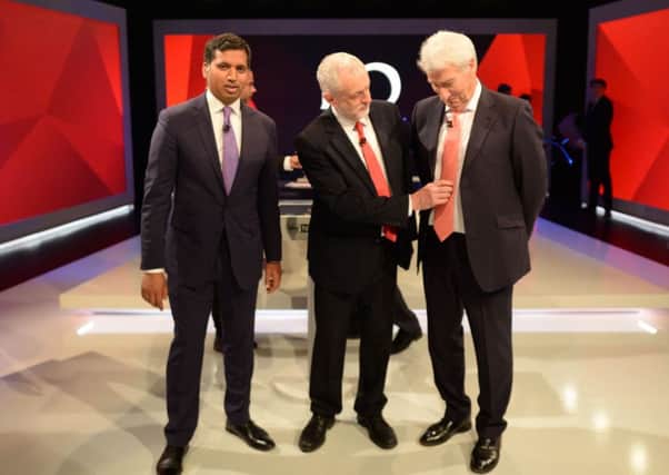 Labour leader Jeremy Corbyn (centre) adjusts the tie of Jeremy Paxman as they stand alongside Sky News political editor Faisal Islam during a joint Channel 4 and Sky News general election programme