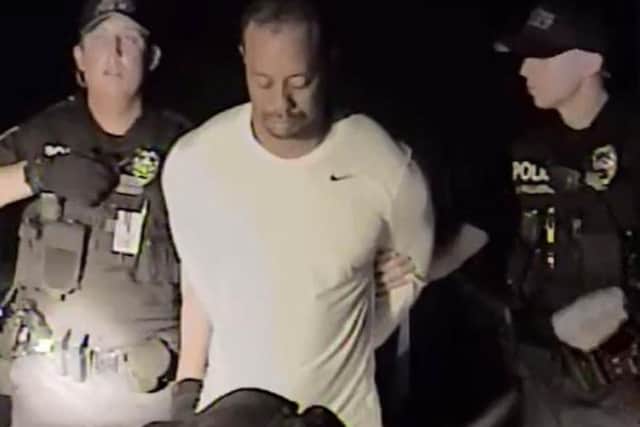 Police dashcam footage shows the golfing great's arrest