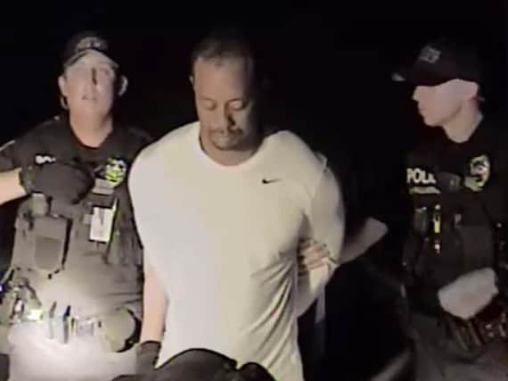 Police dashcam footage shows the golfing great's arrest