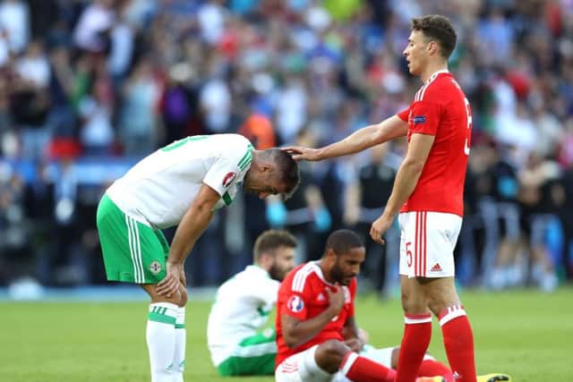 Northern Ireland's Aaron Hughes is dejected at the final whistle after losing 1-0 to Wales at Euro 2016