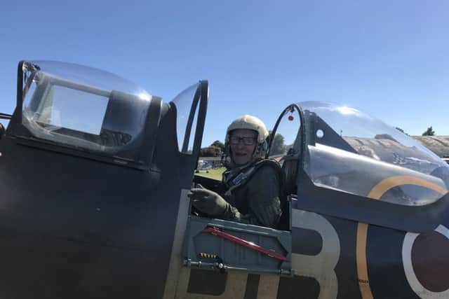 Sam in the cockpit of the fighter plane.