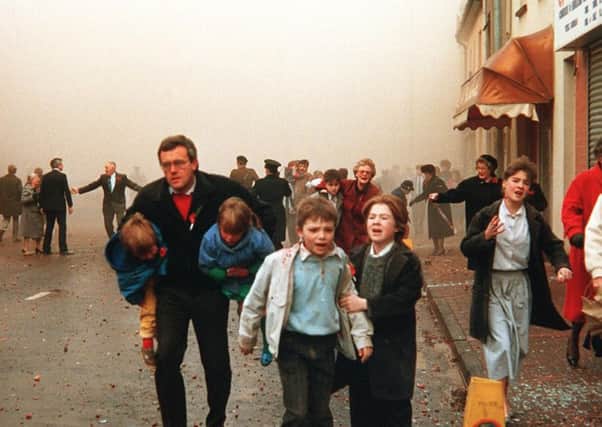 People flee the 1987 Enniskillen bomb, in which 11 civilians were murdered. Picture Pacemaker