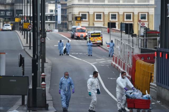 Police forensic officers on London Bridge following Saturday's terrorist incident.  Photo: David Mirzoeff/PA Wire