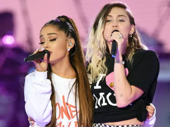 Ariana Grande, left, and Miley Cyrus performing during the One Love Manchester benefit concert for the victims of the Manchester Arena terror attack
