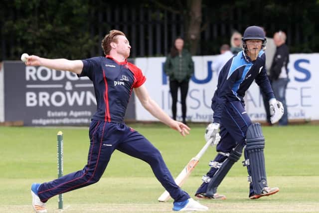 Northern Knights Shane Getkate bowling as Leinster Lightening's Ed Joyce keeps a close eye on him.