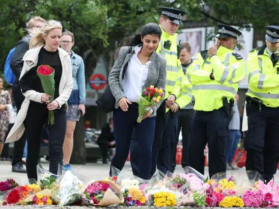 People lay flowers near London Bridge station following Saturday's terrorist attack. Photo: Isabel Infantes/PA Wire