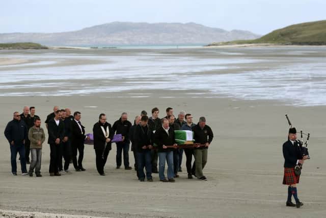 The coffin of Eilidh MacLeod draped in the Barra flag is carried across Traigh Mhor beach at Barra airport after it arrived by chartered plane. The body of the Manchester bomb victim was flown home to the devastated community on the island of Barra ahead of her funeral
