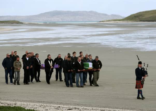 The coffin of Eilidh MacLeod draped in the Barra flag  is carried across Traigh Mhor beach at Barra airport after it arrived by chartered plane. The body of the Manchester bomb victim was flown home to the devastated community on the island of Barra ahead of her funeral