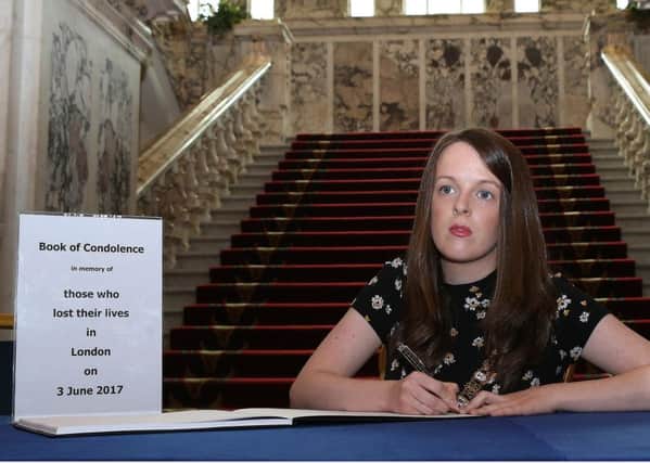 Lord Mayor of Belfast Nuala McAllister opens a book of condolence at Belfast City Hall for those killed in the terror attack in London at the weekend