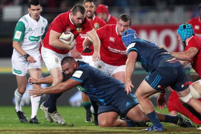 British and Irish Lions' Ken Owen is tackled by Blues'  Charlie Faumuina