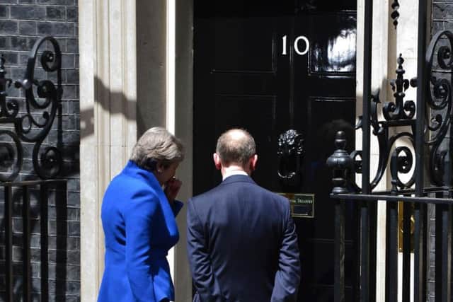 Prime Minister Theresa May, accompanied by her husband Philip enter 10 Downing Street