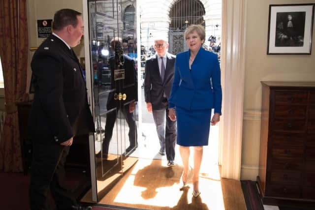 Prime Minister Theresa May and her husband Philip walk into 10 Downing Street after seeing  Queen Elizabeth II where she asked to form a new government. Her authority is now badly wounded. Photo: Stefan Rousseau/PA Wire
