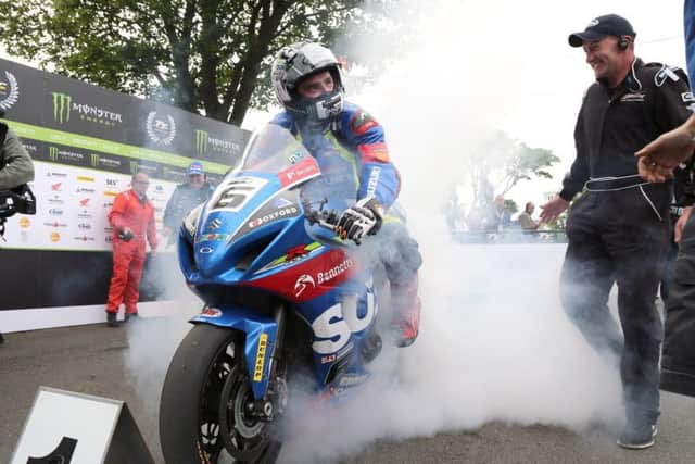 Michael Dunlop celebrates with a burnout after clinching his 15th Isle of Man TT triumph in the showpiece Senior TT.