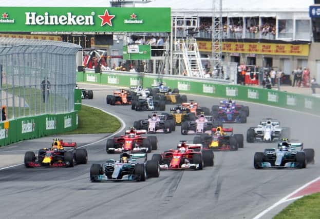 Mercedes driver Lewis Hamilton (44), of Britain, leads the pack at the start at the Canadian Grand Prix in Montreal. (Ryan Remiorz/The Canadian Press via AP)