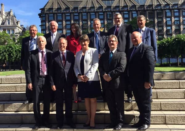 The DUP leader Arlene Foster with the party's ten MPs outside the Houses of Parliament in Westminster, London, where they now hold the balance of power. Photo: DUP/PA Wire