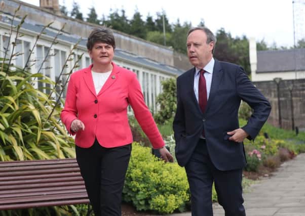 DUP leader Arlene Foster and Nigel Dodds speak to the media at Stormont Castle in Belfast ahead of talks aimed at restoring powersharing in Northern Ireland. Photo: PA