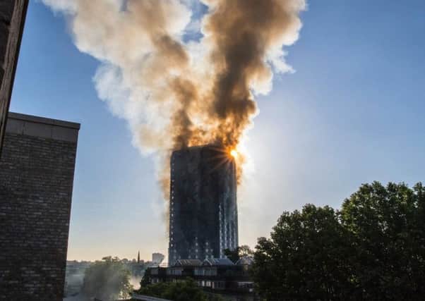 Smoke billows from a fire that engulfed the 27-storey Grenfell Tower in west London.