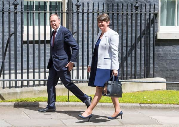 DUP leader Arlene Foster and DUP deputy leader Nigel Dodds arriving at 10 Downing Street in London for talks on a deal to prop up a Tory minority administration. Photo: Dominic Lipinski/PA Wire