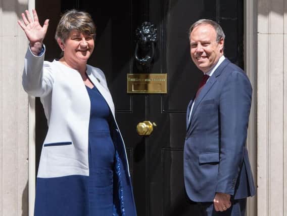 DUP leader Arlene Foster and DUP deputy leader Nigel Dodds arriving at 10 Downing Street in London for talks on a deal to prop up a Tory minority administration. Photo: PA