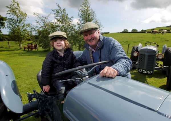 Press Release Image
Â©Press Eye Ltd Northern Ireland 
Photography by Matt Mackey  /presseye.com

Robert Berry, Farm Manager at the Ulster Folk & Transport Museum in Cultra, shows budding farmer Matthew Gardner from Holywood some of the fleet of Ferguson tractors that will be on display at the museum at this years Ferguson Heritage Tractor Working Day, organised in association with the Ferguson Heritage Tractor Society. The event takes place on the grounds of the Folk Museum on Saturday 24 June, where visitors will get the chance to view the vintage vehicles in Ballycultra Town, while working demonstrations will take place in the rural museum. The event runs from 10am to 5pm. More details can be found at www.nmni.com/uftm