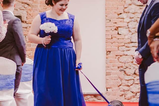 Undated Lauren Owens Photography handout photo issued by the Dogs Trust of a formerly homeless dog named Maddie accompanying one of the bridesmaids down the aisle at her owner's wedding