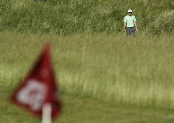 Rory Mcilroy, of Ireland, makes his way to the 12th hole during the first round of the U.S. Open