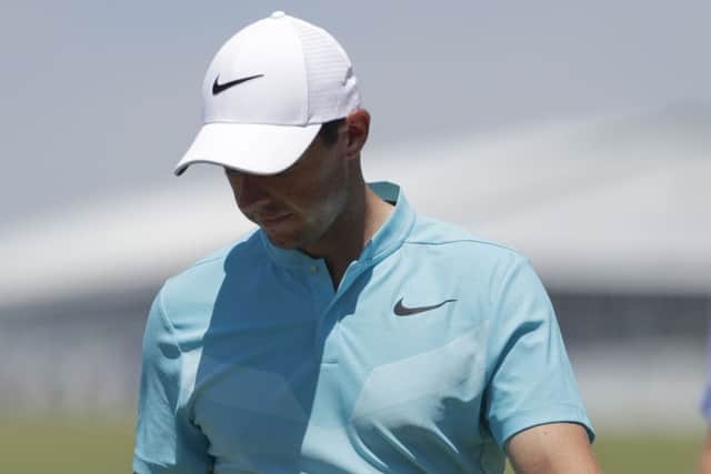 Rory McIlroy, of Ireland, looks down at his ball