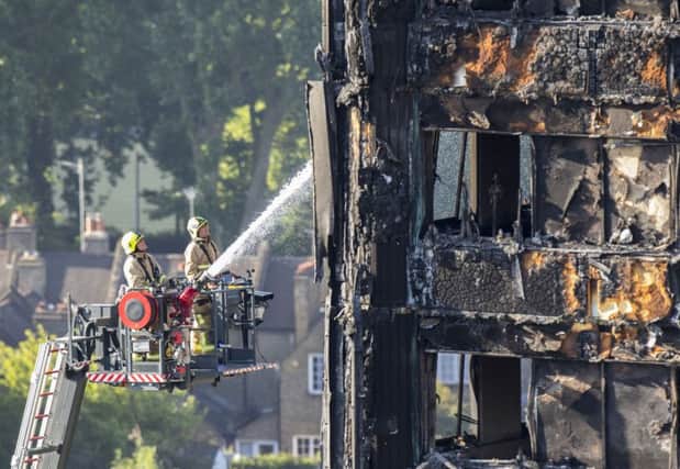 Water is sprayed on Grenfell Tower in west London after a fire engulfed the 24-storey building on Wednesday morning. PRESS ASSOCIATION Photo. Picture date: Friday June 16, 2017. Seventeen people have died and more are feared dead after a huge fire destroyed the tower block in north Kensington. See PA story FIRE Grenfell. Photo credit should read: Rick Findler/PA Wire