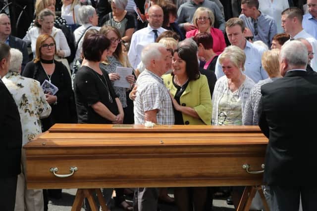 Seamus Ruddy's Sisiter Anne Morgan (centre) is comforted during his funeral at St Catherine's Dominican Chapel in Newry Co Armagh.  Niall Carson /PA Wire