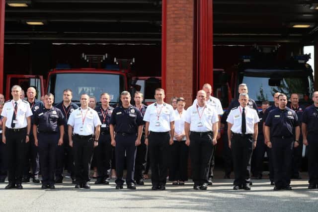 Firefighters and staff observe a minute's silence at Manchester Community Fire Station, in memory of those who died in the Grenfell Tower fire in west London last week