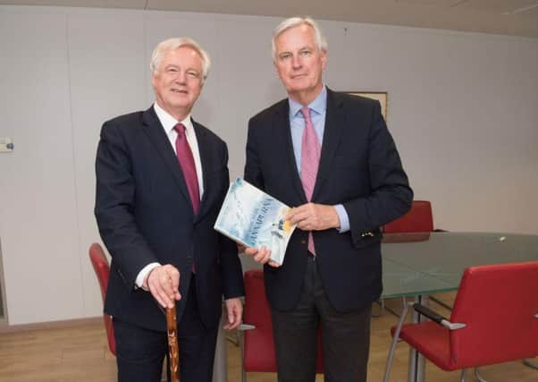Department for Exiting the EU handout photo of Brexit Secretary David Davis exchanging mountaineering gifts with European Commission's chief negotiator Michel Barnier at the commission's Berlaymont headquarters in Brussels
