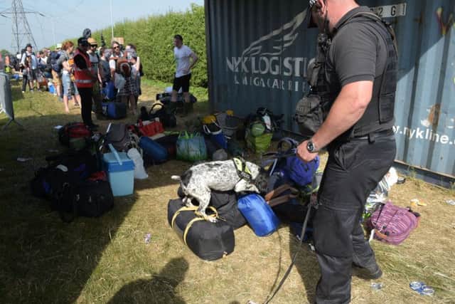 Sniffer dogs at the entrance gate during the Glastonbury Festival at Worthy Farm in Pilton, Somerset. Pic: Ben Birchall/PA Wire