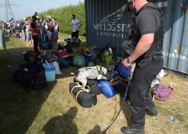 Sniffer dogs at the entrance gate during the Glastonbury Festival at Worthy Farm in Pilton, Somerset. Pic: Ben Birchall/PA Wire
