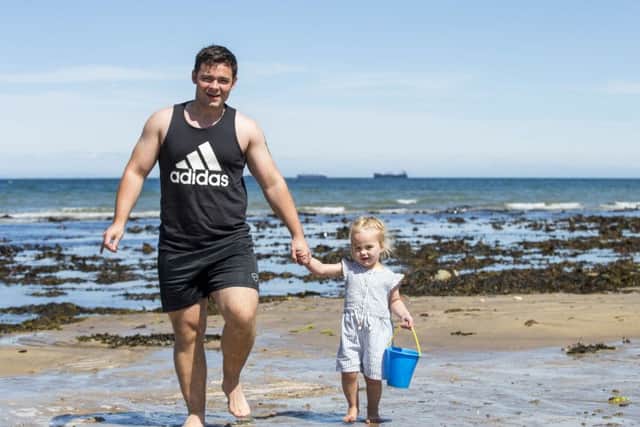 John Paul Brown with his 2-year-old daughter Sophia enjoying the weather at Crawfordsburn Country Park beach on Wednesday June 21, the longest day. Photo: Liam McBurney/PA Wire