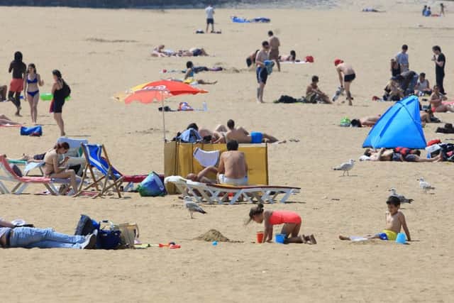 People enjoy the hot weather on the beach in Margate, Kent. Photo: Gareth Fuller/PA Wire