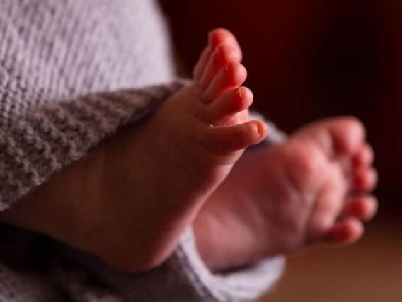 File photo dated 23/01/16 of the feet of a new baby wrapped in a blanket. One in eight health bodies have higher-than-expected rates of stillbirths and neonatal death, a new report suggests