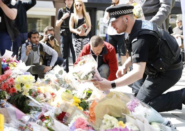 Flowers are left in St Anns Square, Manchester, the day after a suicide bomber killed 22 people, on May 22