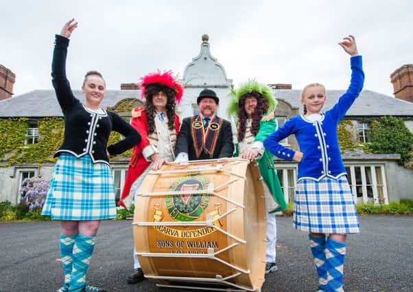 This year's annual sham fight at Scarva will offer an added cultural experience for visitors. Pictured with highland dancers ahead of next month's flagship event are Sandy Heak, chairman of the Royal 13th organising committee (centre), King William (second from left) and King James. INBL scarva