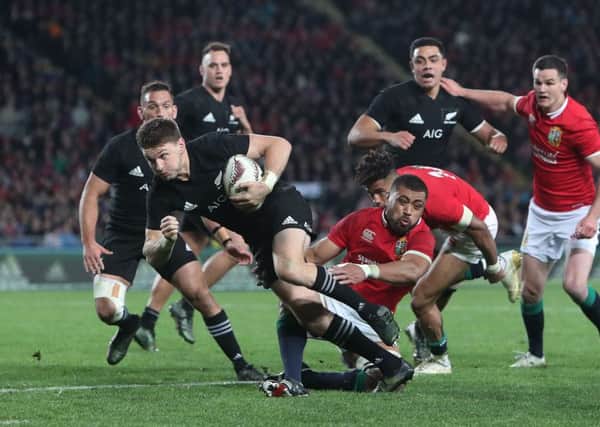 New Zealand's Beauden Barrett is tackled by British and Irish Lions' Taulupe Faletau