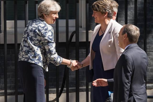Prime Minister Theresa May greets DUP leader Arlene Foster, DUP deputy leader Nigel Dodds and DUP MP Sir Jeffrey Donaldson outside 10 Downing Street in London ahead of talks aimed at finalising a deal to prop up the minority Conservative Government