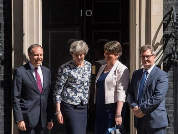 Prime Minister Theresa May greets DUP leader Arlene Foster, DUP deputy leader Nigel Dodds and DUP MP Sir Jeffrey Donaldson outside 10 Downing Street