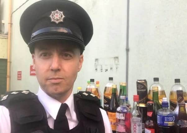 Chief Inspector Jon Burrows with some of the booze seized during Operation Snapper.
